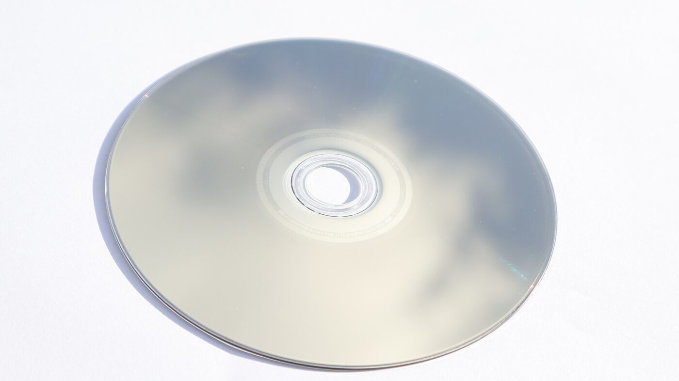 A Blu-ray disc lying data side up on a plain white surface