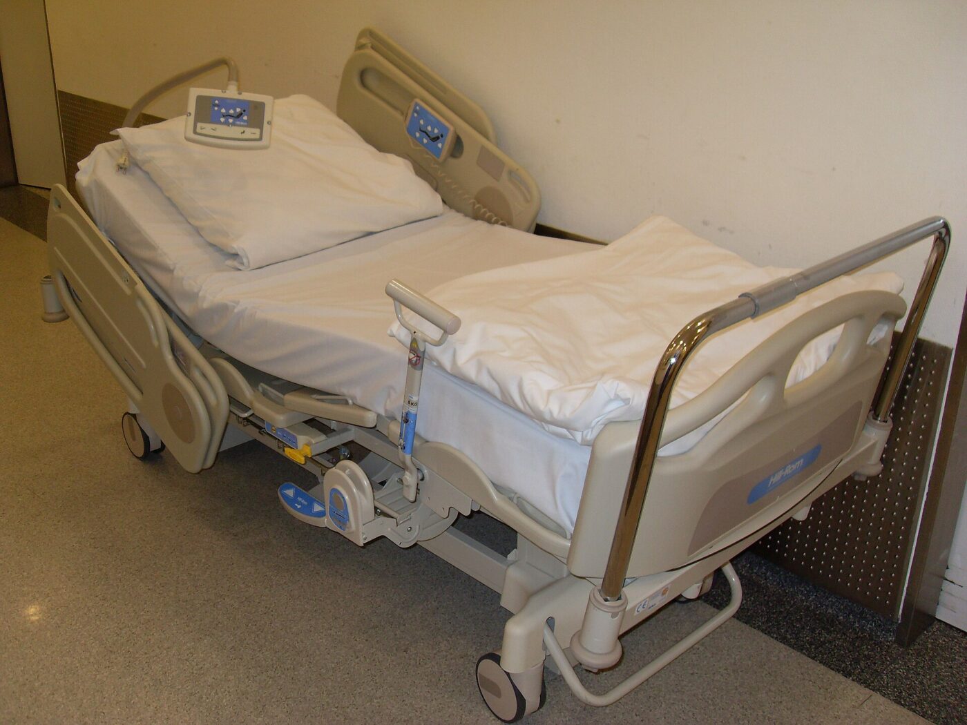 A hospital bed with built-in side rails; the federal portable bed rail rule excludes hospital beds.