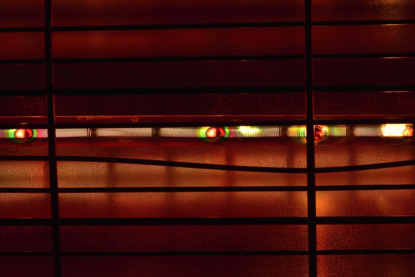 The quartz tubes of a halogen heater glowing orange behind the wire guard.