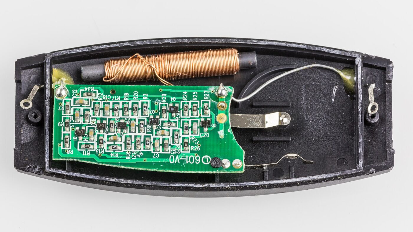The circuit board and antenna coil inside an opened heart rate chest strap transmitter.