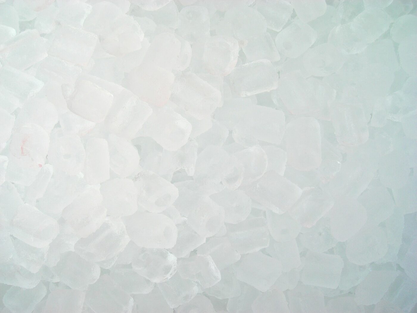A heap of small hollow cylinders of ice, the kind served in drinks.