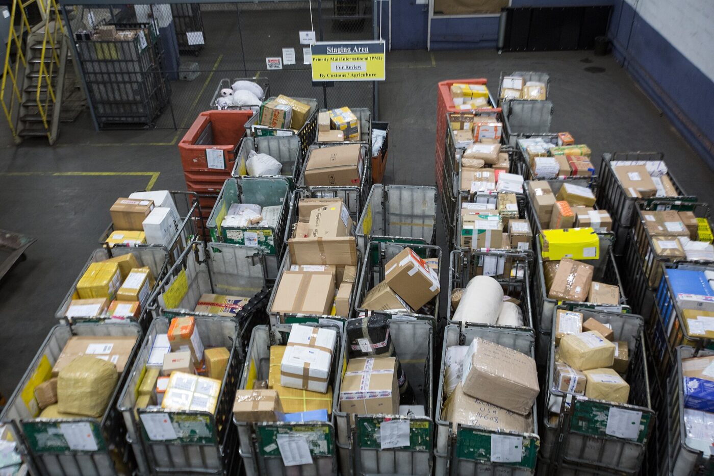 Inbound international parcels sorted into bins at the JFK International Mail Facility
