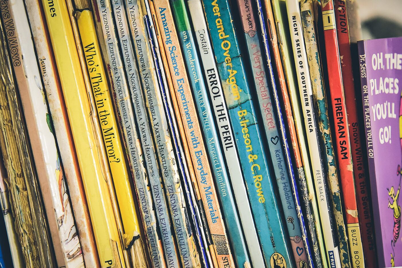 Colorful children's book spines packed tightly together on a shelf.