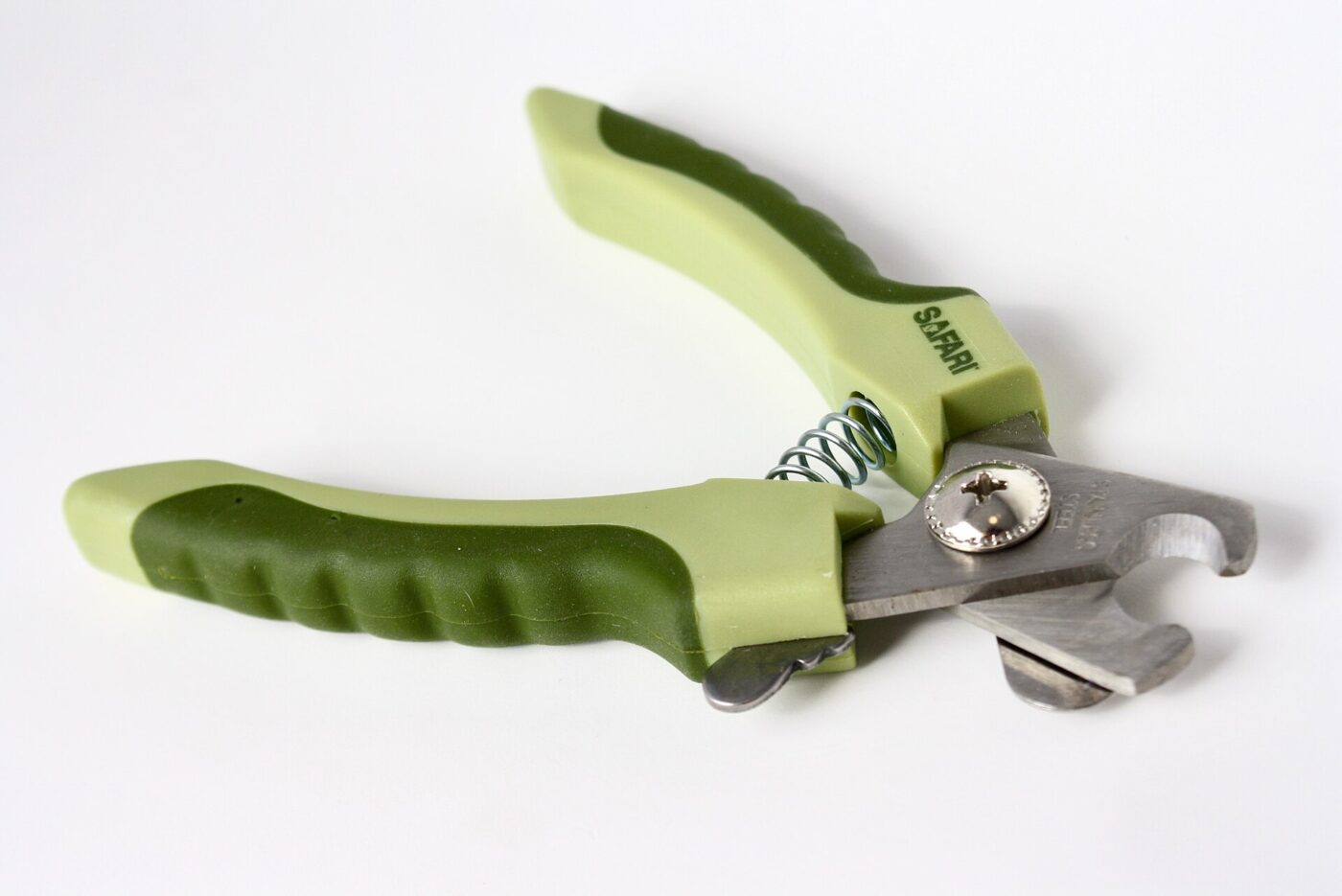 A pair of dog nail clippers with green rubber-grip handles on a white background
