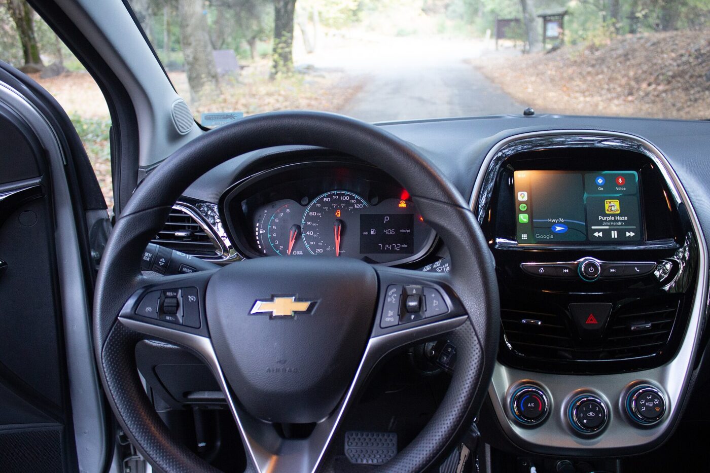 The dashboard of a Chevrolet hatchback with a phone-projection screen running on its center touchscreen
