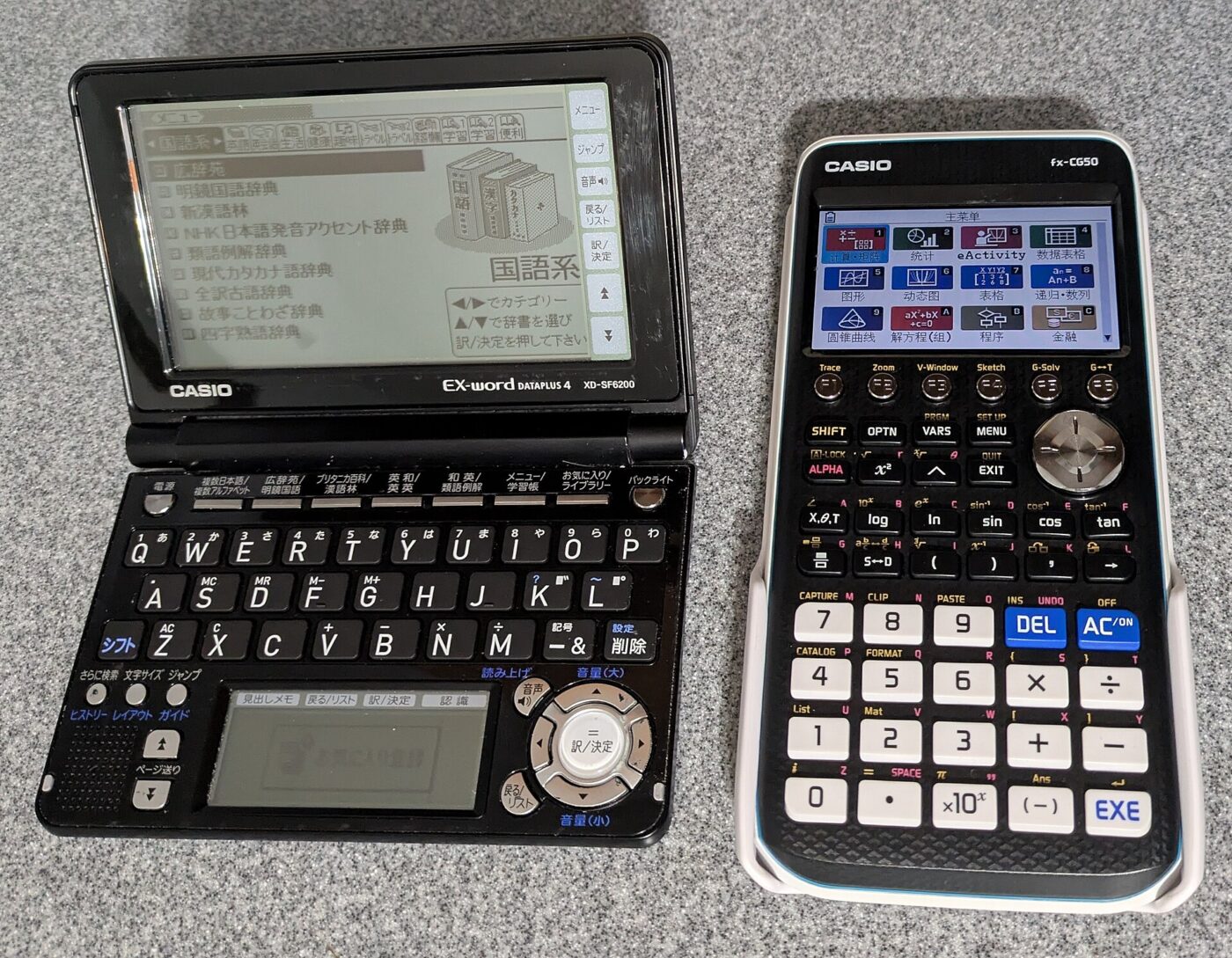 A color-screen Casio graphing calculator next to a Casio electronic dictionary with a full keyboard