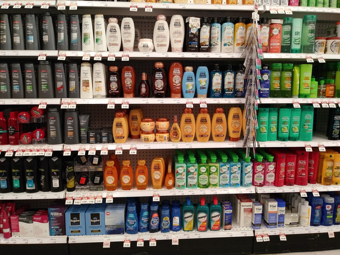 Rows of shampoo and hair care products on a store shelf