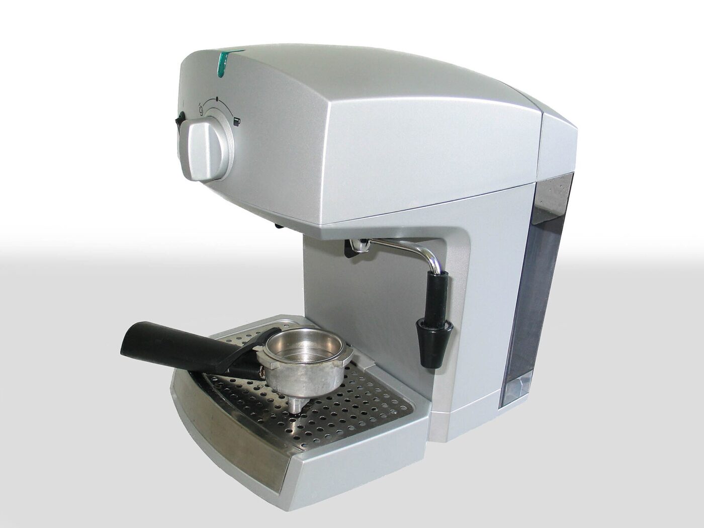A compact semi-automatic home espresso machine with a portafilter and drip tray on a white background