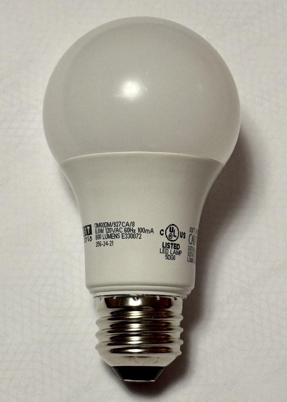 An LED bulb with its wattage and 800-lumen output printed on the neck.
