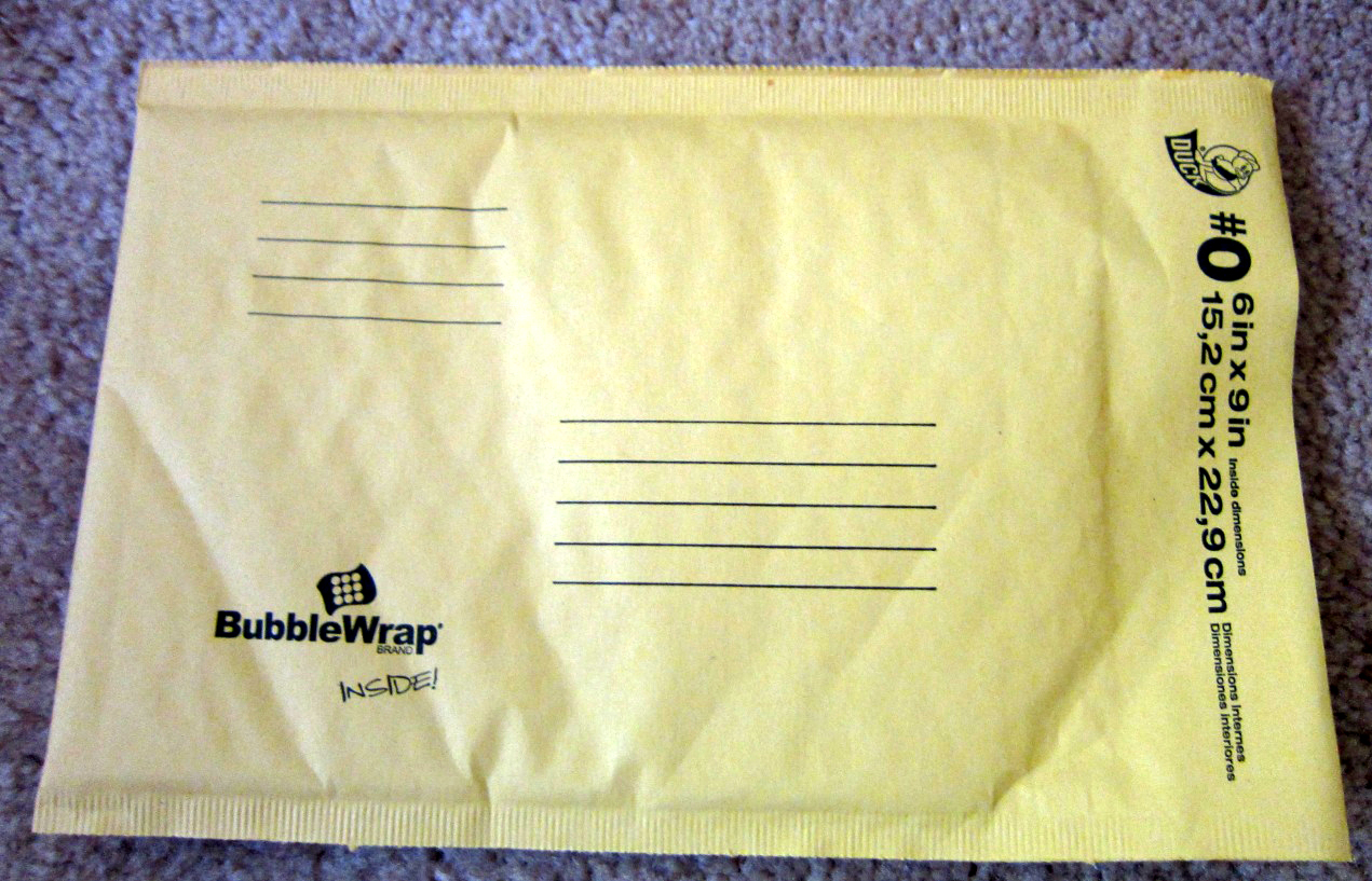 A small kraft padded mailer with a plastic bubble lining inside.