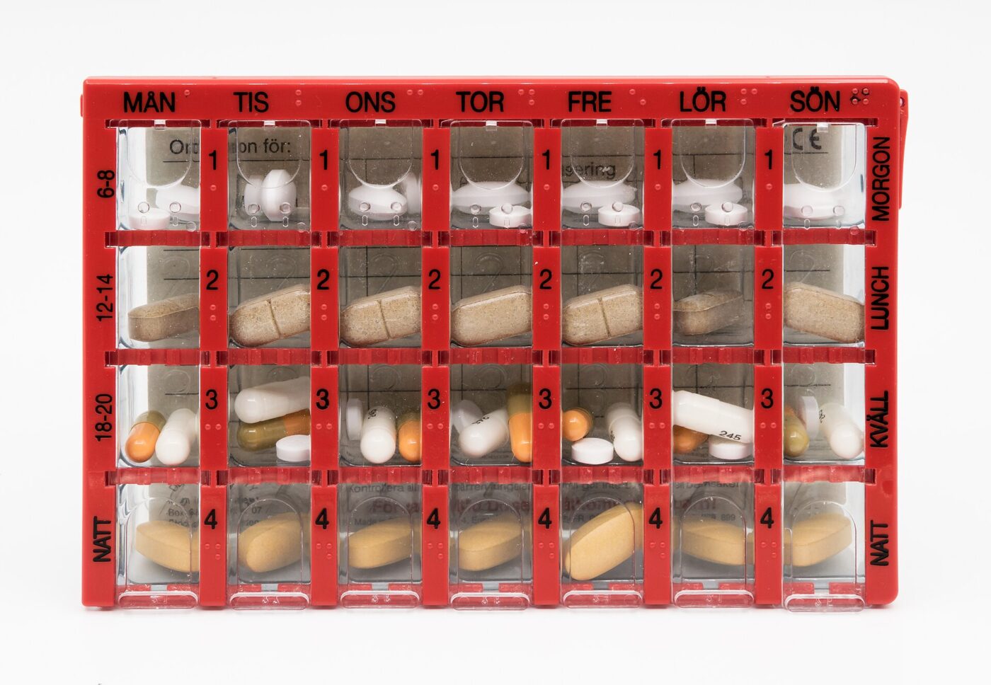 A weekly organizer with four compartments for every day, each one holding that dose's tablets