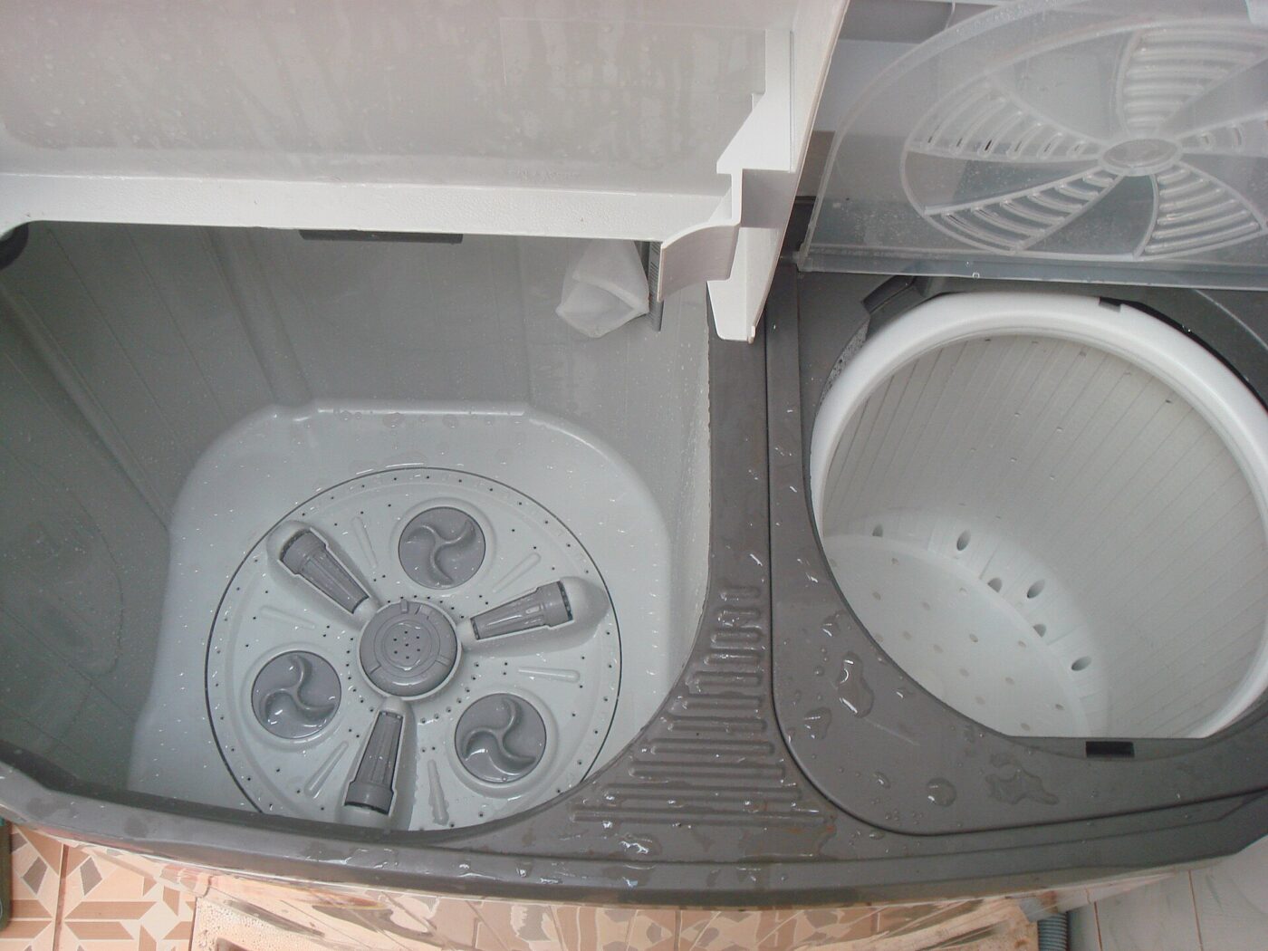 Looking down into an open twin-tub portable washer, with wash tub and spin basket.