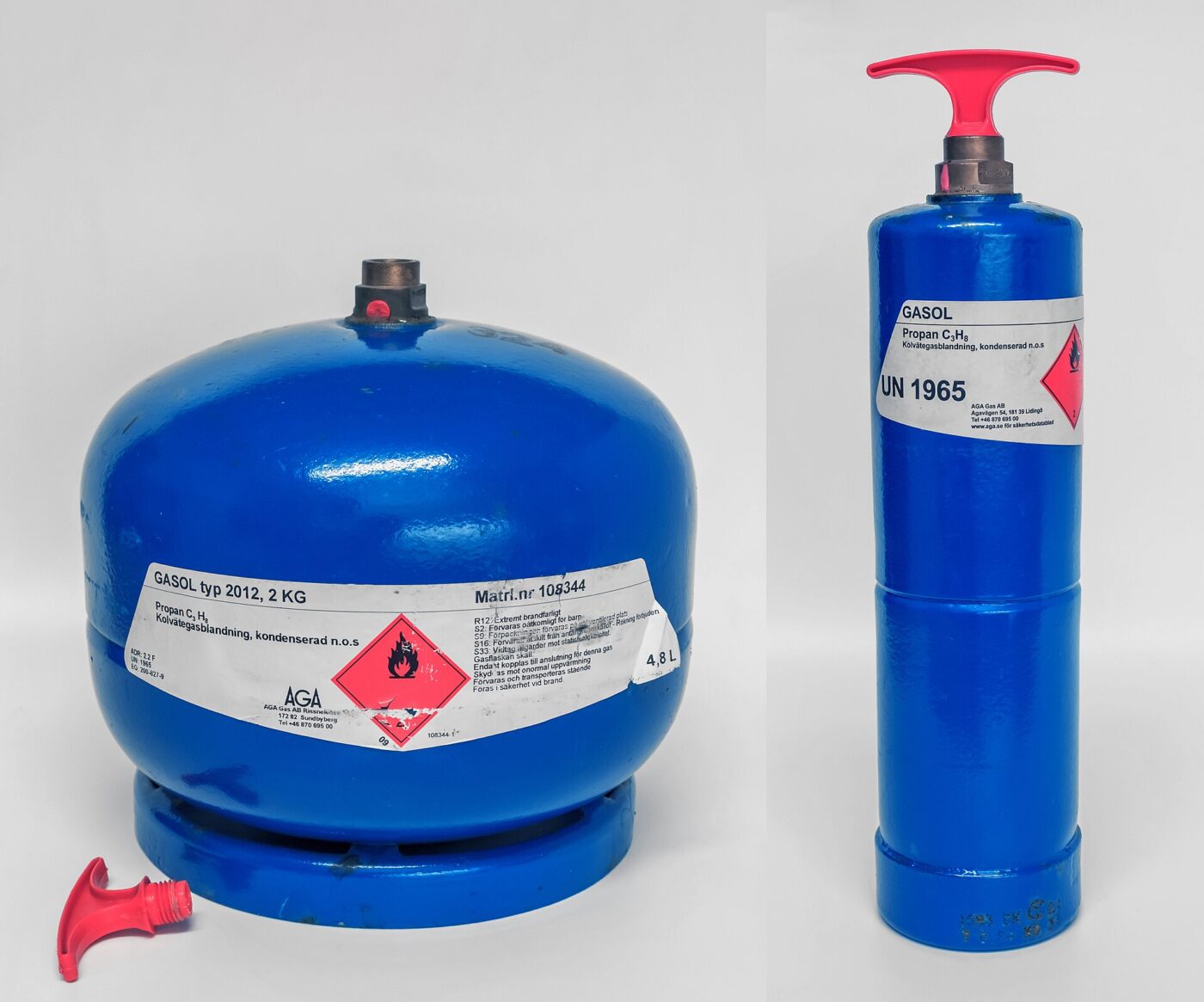 Two refillable propane cylinders, one squat and one tall, standing against a plain white background