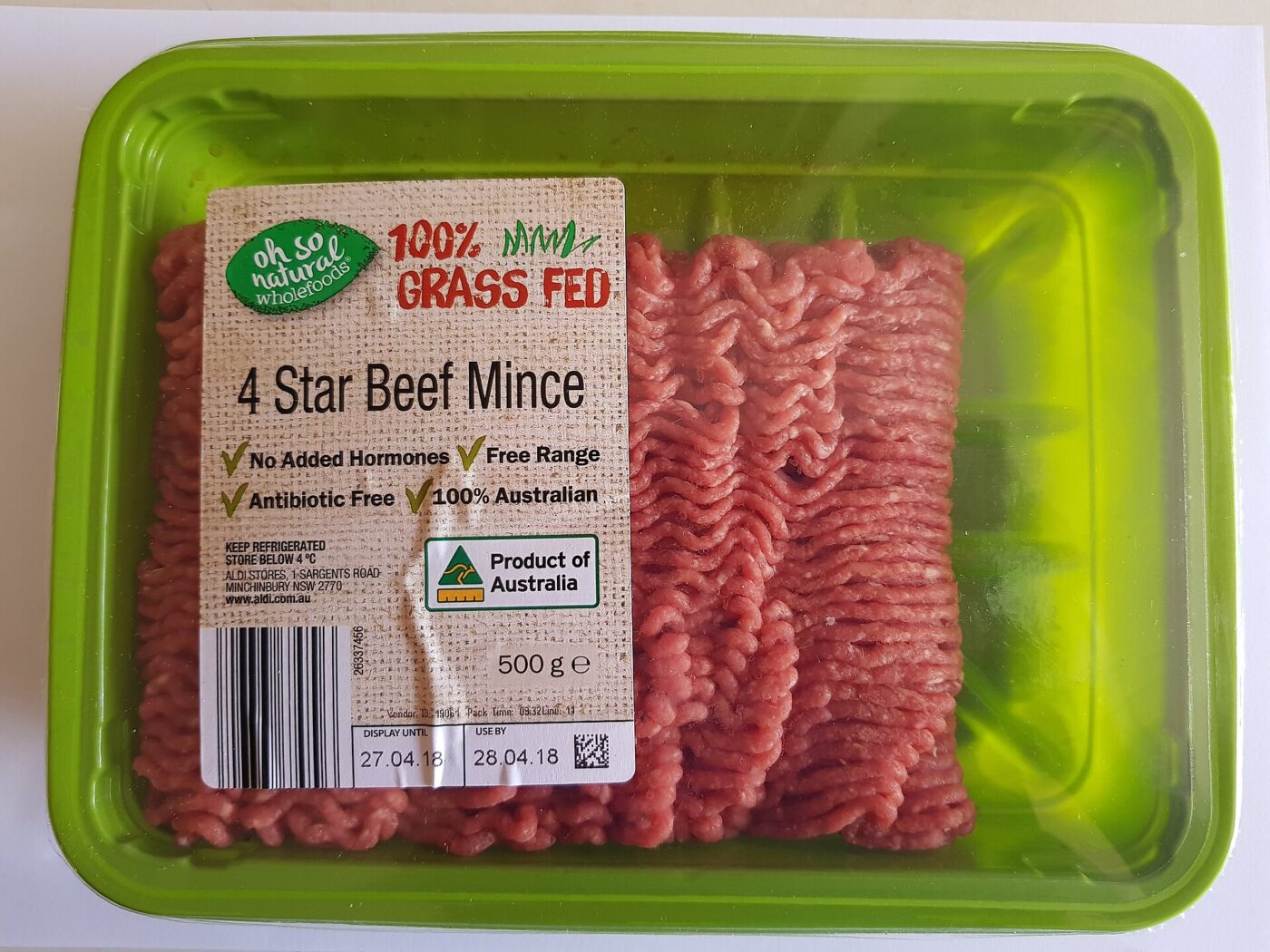 A supermarket tray of grass-fed beef mince sealed under clear plastic wrap
