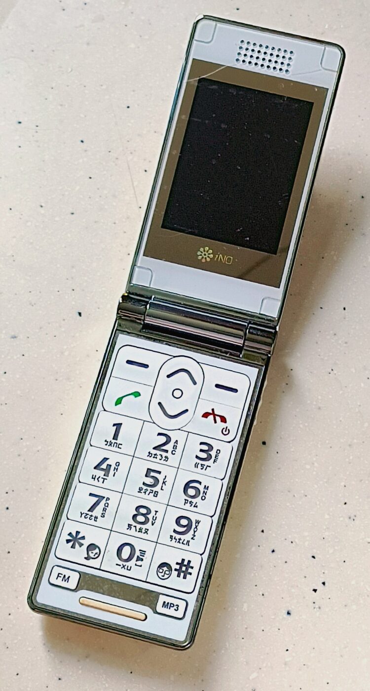An open flip phone with oversized number keys and green and red call buttons