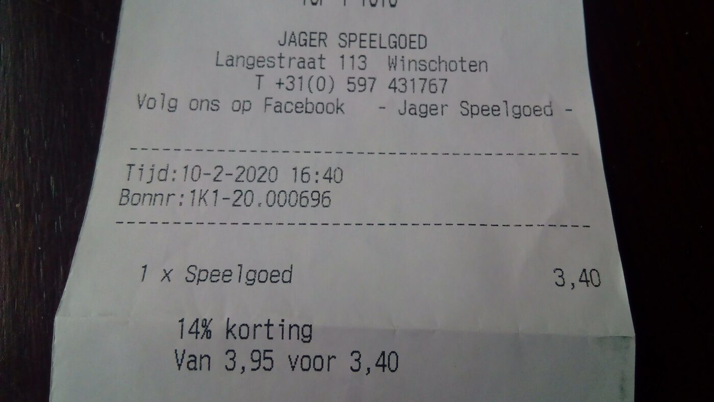 A printed thermal paper receipt from a shop till, lying on a counter.