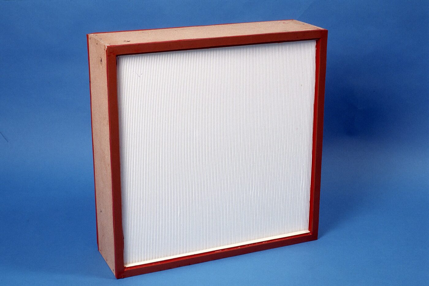 A HEPA filter panel in a wooden frame, its pleated white media facing the camera.