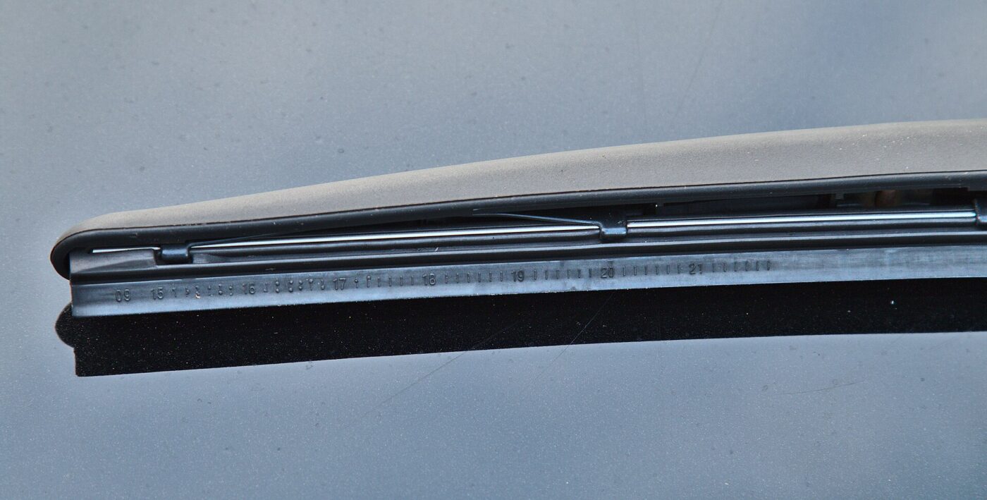 A single windshield wiper blade photographed on a plain background