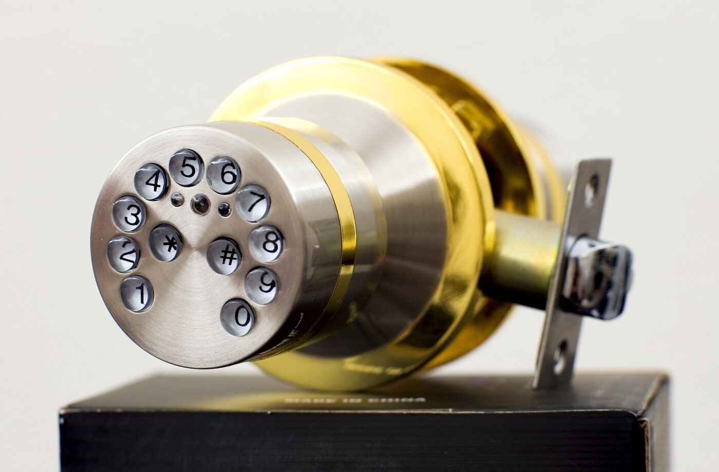 A keypad entry knob lock shown off the door, with the digits set into its face.
