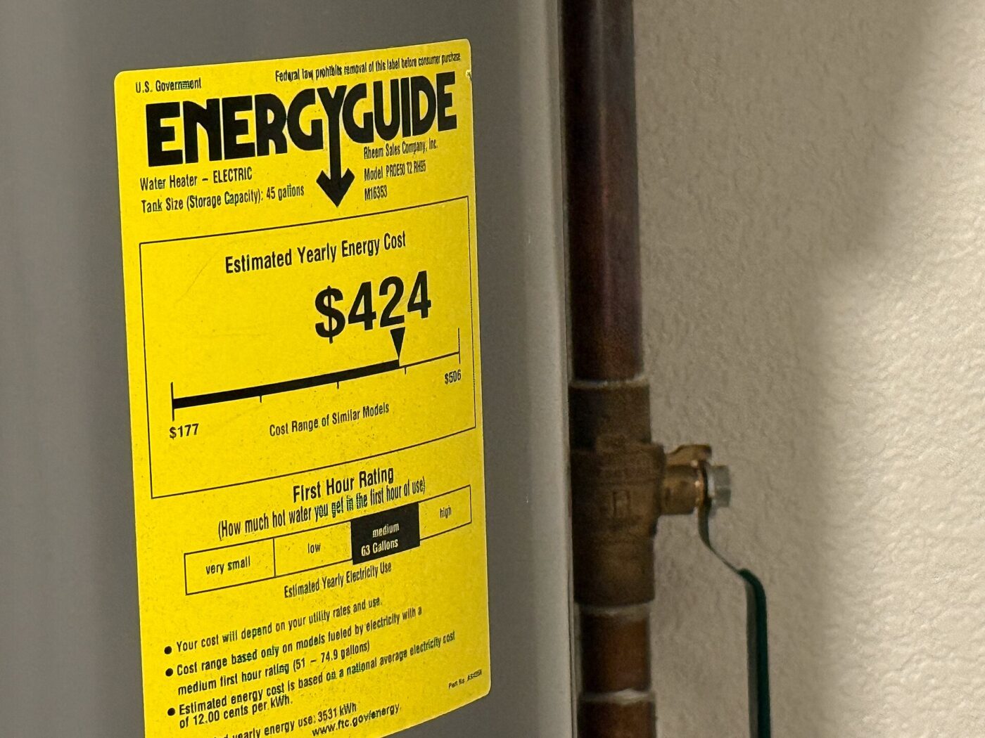 A federal EnergyGuide label on an electric water heater listing an estimated yearly energy cost